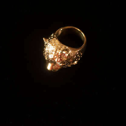 An aerial view of a ring shaped like a snow leopard against a black background.