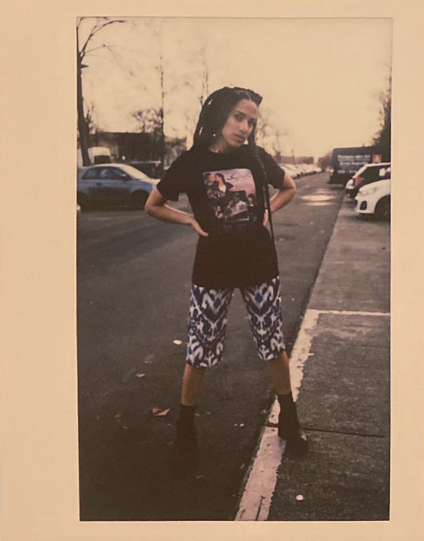 A polaroid of woman with braids on a street in Berlin.